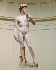 36. Michelangelo Buonarroti, David, 1504, CE, Galleria dell Accademia, Florence, marble. Commissioned by the Cathedral of Florence, David was to be placed in a top niche but was placed on the plaza of Florence's government building instead, representing Florence as a powerful state. It is elongated and disproportional (having longer legs), like Doryphoros's Canon. Unlike Donatello's and Verrocchio's David, its head abruptly turns toward Goliath, showing anticipation. Its colossal, muscular body - typical of Michelangelo - and stern facial expression exert tension and energy. Undercutting created muscles; drilling created curly hair. This unpolished sculpture has archaic smile and facial expression which differs on angle viewed. Many High Renaissance sculptures are Greco-Roman biblical heroes.