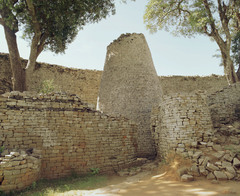 Conical tower and circular wall of Great Zimbabwe Southeastern Zimbabwe, Shona peoples. c. 1000-1400 C.E. Coursed granite blocks In some places, the walls are several meters thick, and many of the massive walls, stone monoliths and conical towers are decorated with designs or motifs. Patterns are worked into the walls, such as herringbone and dentelle designs, vertical grooves, and an elaborate chevron design decorates the largest building called the Great Enclosure