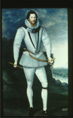 Elizabethan. Elongated body, peascod shaped doublet, short pumpkin breeches over canions. Leg-o-mutton sleeves, ruff and metal gorget around his neck. The garter indicates his membership. Crescents on his shoulders.