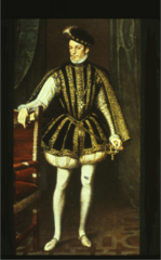 Elizabethan. Full-skirted jerkin over a cream doublet. Padded pumpkin hose, slashed shoes, hanging sleeves. His jerkin may be peascodded. The shoes are wide and slashed. Note the small ruff. His costume is a blend of English and Italian.
