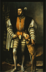 He is wearing upper stocks with a leather jerkin and a coat with black revers. Codpiece. Note the large puffed sleeves, the order and his duck-billed shoes. Flat cap.