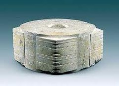 Jade cong Liangzhu, China. 3300-2200 B.C.E. Carved jade. Like one of many, this was a jade piece with decorative carvings, unique shape, and symbolic purpose. The stone might have held spiritual or symbolic meanings to the early cultures of China.