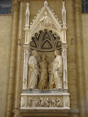 Quattro Santi Coronati by Nanni Di Banco, 15th Cen. Italian Ren
- Or San Michele cathedral 
- originally meant to be viewed from outside inside 
- group of sculptors, masons, etc w/classical attire and serious folding 
- controppasto pose, protruding
- feet project out, begin to enter viewer's space, integration of human figures in space, monumental size .. saved w/semicircular positioning 
- entire section carved into space itself
- individuality 
- right: open mouth = speaking, other pointing, 2 listening/pondering .. psychological linking of characters 
- reduced incised shrunken columns, really miniscule, changing 
- humanism and roman form, intensity of saints reverts back to earlier portrayal 
- imperial portraiture