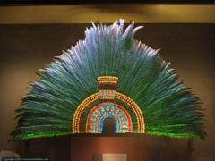 Ruler's feather headdress (probably of Motecuhzoma II) Mexica (Aztec). 1428-1520 C.E. Feathers (quetzal and cotinga) and gold He headdress was probably part of the collection of artefacts given by Motecuhzoma to Cortés who passed on the gifts to Charles V. The headdress is made from 450 green quetzal, blue cotinga and pink flamingo feathers and is further embellished with gold beads and jade disks.