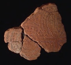 Terra Cotta Fragment Lapita. Solomon Islands, Reef Islands. 1000 B.C.E. Terra cotta (incised) One of the first examples of the Lapita potter's art, this fragment depicts a human face incorporated into the intricate geometric designs characteristics of the Lapita ceramic tradition.